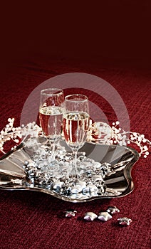 Champagne glasses on red