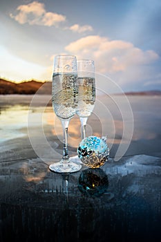 Champagne glasses stand on the ice of the frozen Lake Baikal.