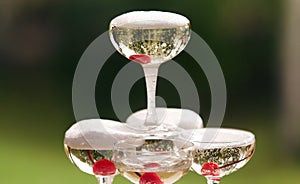 Champagne glasses standing in a tower at a festive event, party or wedding reception. Champagne pyramid.