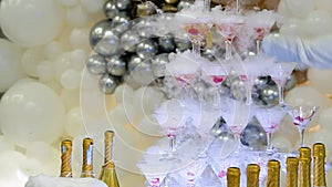 Champagne glasses standing in a tower at the wedding party. Champagne glass pyramid. Pyramid of glasses of wine