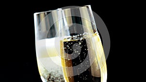 champagne with golden bubbles on black background
