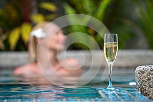 Champagne near swimming pool on a background of a beautiful woman