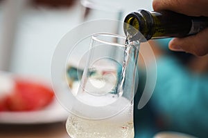 Champagne poured from a bottle into a champagne glass