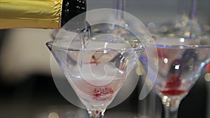 Champagne pouring in two glasses from a bottle. Two Champagne Glass On Defocused