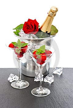 Champagne, red rose and strawberries over white