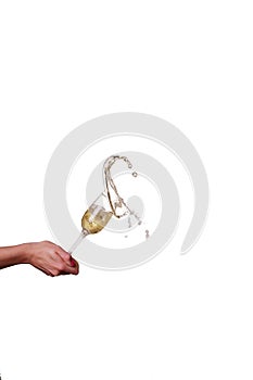 Champagne splash from glass with female hand