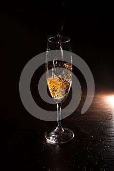 Champagne splash in motion on black background