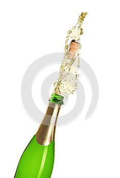 Champagne splashing out of bottle on background