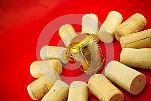 Champagne stopper surrounded by cork stoppers
