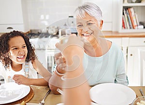 Champagne toast and grandmother for mothers day celebration in home kitchen dining room with children. Happy elderly