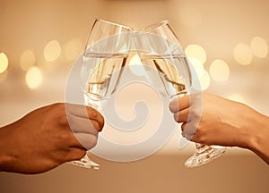 Champagne, toast and hands, a celebration with couple on romantic date drinking with bokeh. Love, romance and luxury, a