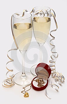 Champagne, wedding bands and mouse in heart