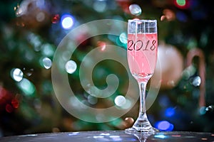 Champagne or wine 2018 glass on sparkling background