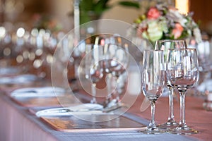 Champagne and wine glasses on decorated table at wedding reception