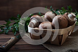 Champignon mushrooms on wooden background