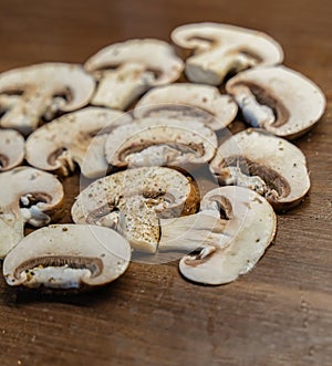 Champignon sliced into slices on a wooden background