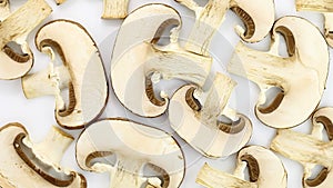 Champignons mushrooms brown, cut into flat pieces, rotation counterclockwise, turning, top view.