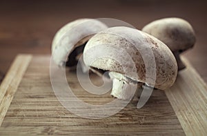 Champignons mushrooms on a wooden board.