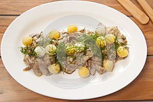 Champignons with potatoes and white sauce. European cuisine