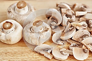 Champignons are on a wooden table. Close-up
