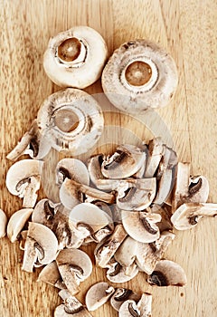 Champignons are on wooden table. View from above