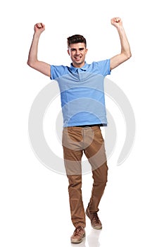 Champion casual man celebrating with fists in the air