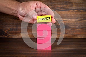 Champion Concept. Colorful blocks in a pile on a wooden texture background