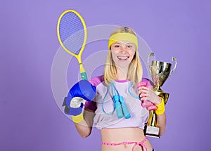 Champion concept. Girl sport instructor hold golden goblet of winner or champion. Woman good in tennis jumping boxing