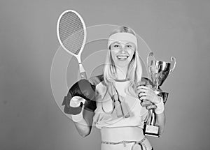 Champion concept. Girl sport instructor hold golden goblet of winner or champion. Woman good in tennis jumping boxing