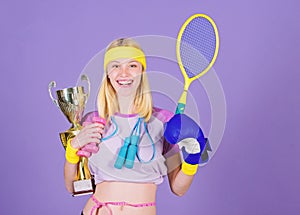 Champion concept. Girl sport instructor hold golden goblet of winner or champion. Woman good in tennis jumping boxing