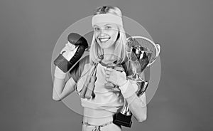 Champion concept. Girl successful modern woman hold golden goblet of champion. Woman good in tennis jumping boxing