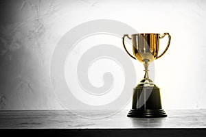 Champion golden trophy placed on wooden table