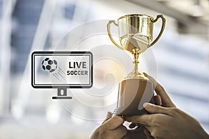 Champion golden trophy for winner background with live soccer sc