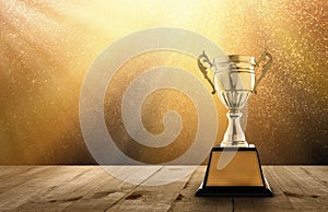 champion golden trophy on wood table with copy space and gold Twinkly Lights and glitter stars light background copy space ready photo