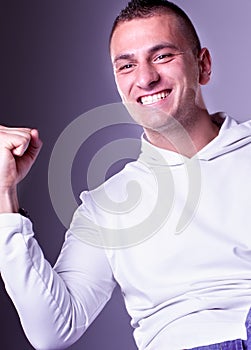 Champion man with fists clenched in victory
