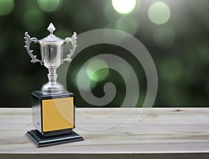 Champion silver trophies on wood table