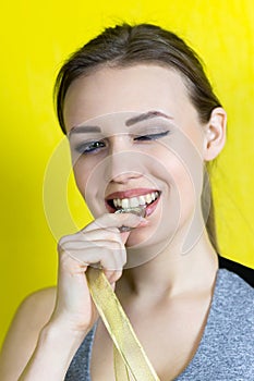 The champion of sports competitions bites his gold medal.