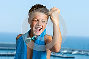 Champion teen swimmer pulling a fist.