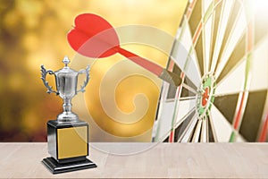 Champion trophy placed on wooden table.