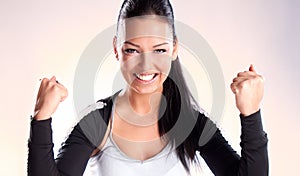 Champion woman with fists clenched in victory