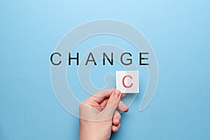 Chance and change concept. Hand with a white sticker on a blue background