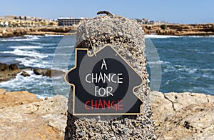 A chance for change symbol. Concept words A chance for change on beautiful black chalk blackboard. Beautiful stone blue sea sky