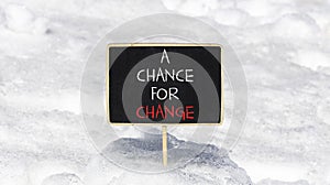 A chance for change symbol. Concept words A chance for change on beautiful black chalk blackboard. Beautiful white snow background