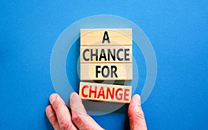 A chance for change symbol. Concept words A chance for change on beautiful wooden block. Beautiful blue table blue background.