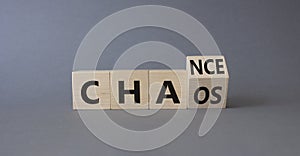 Chance vs Chaos symbol. Turned wooden cubes with words Chaos and Chance. Beautiful grey background. Psychology and Chance vs Chaos