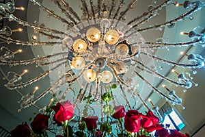 Chandelier hanging over lobby with stair and luxury hall