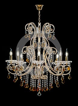 Chandelier for interior of the living room. chandelier decorated with crystals and amber isolated on black background.