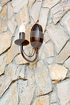Chandelier lamp on ashlar wall photo