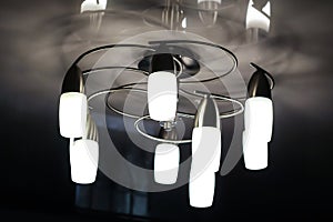 Chandelier with long plafonds on a light ceiling