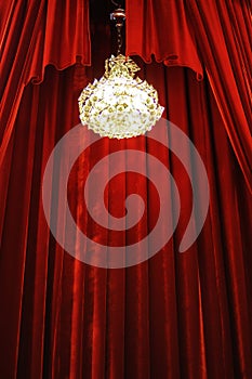 Chandelier with red curtains